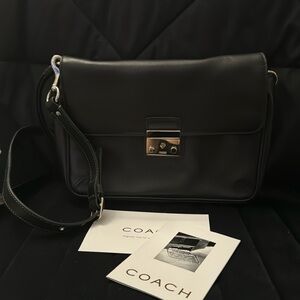 Black leather Coach purse. Signature.